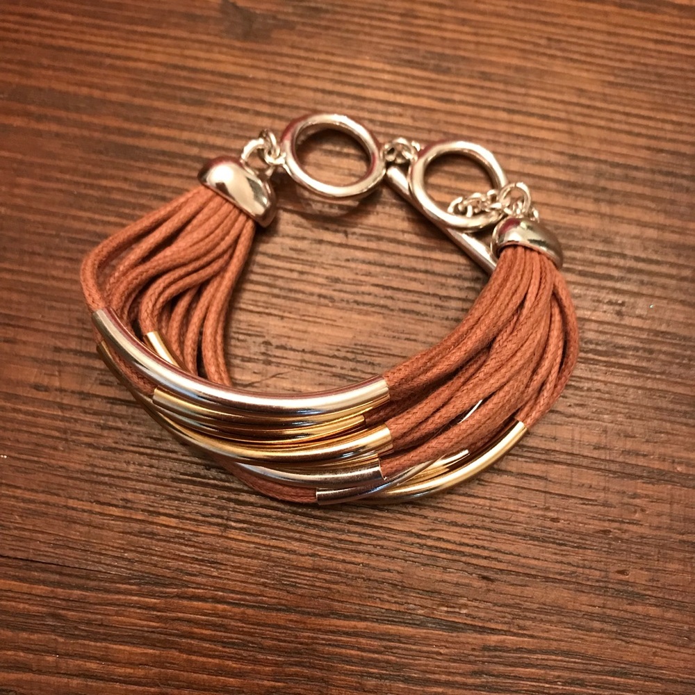 Tan and silver colored multi strand bracelet
